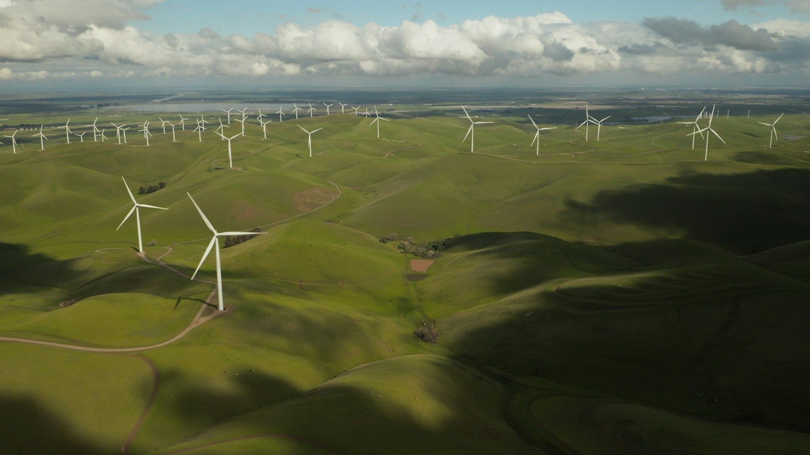 Wind farm across green hills